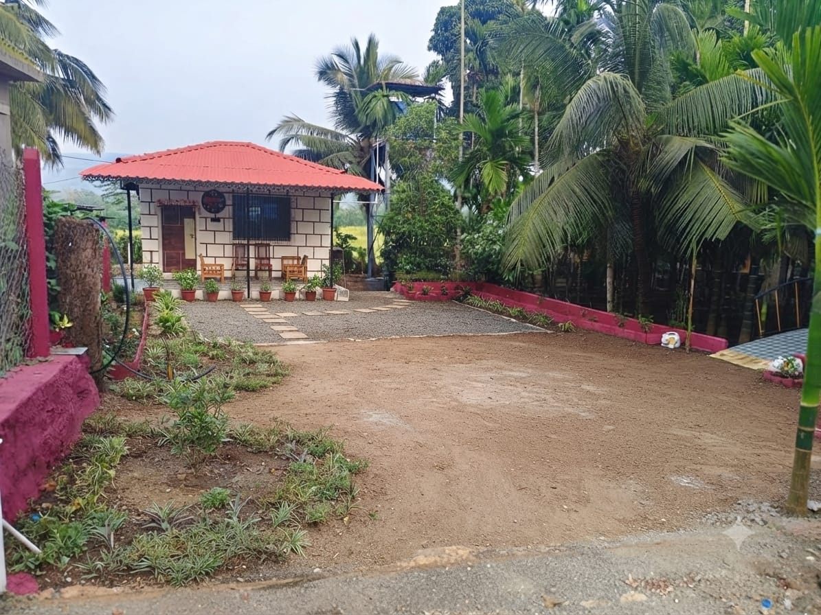 Cottage with sit-out chairs and an open courtyard for parking