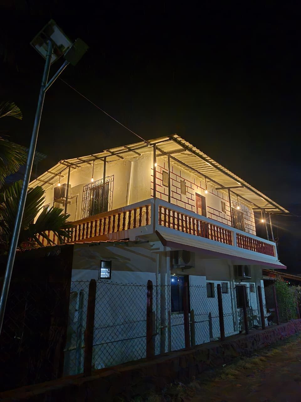 The two-storey guest building lit up at night